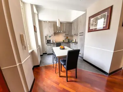 a small kitchen with a white table and chairs at Charming apartment in San Giovanni 90m from Metro in Rome
