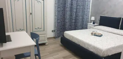 a bedroom with a bed and a desk with a purse on it at In Terrazza Da Giusy in Rome