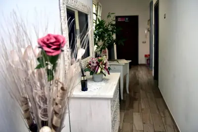 a hallway with flowers in vases and a mirror at In Terrazza Da Giusy in Rome