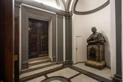 a statue of a man sitting on a chest in a room at Novembre 152 Apartment in Rome