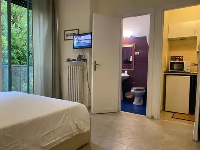 a bedroom with a bed and a bathroom with a toilet at Suite Marilyn - Flaminio - Olimpico - Auditorium in Rome