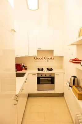 a kitchen with white cabinets and a stove at Cathy's Luxury Home in Rome