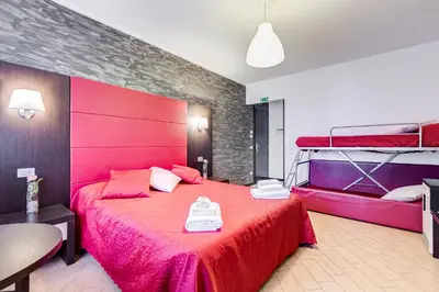 a bedroom with a bed and a vase with flowers in it at Dreams Of Rome in Rome