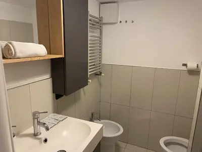 a bathroom with a sink and a toilet at Heart of San Lorenzo - La casa particular in Rome