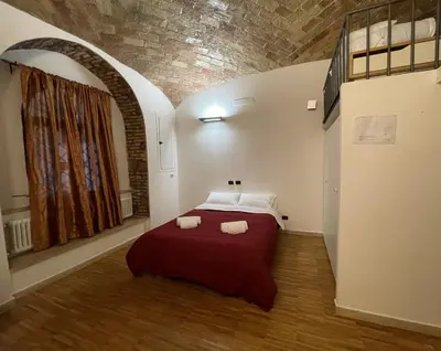 a woman is looking at her cell phone at Heart of San Lorenzo - La casa particular in Rome