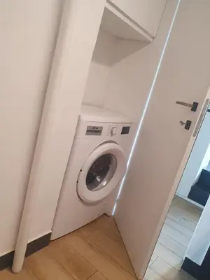 a washer and dryer in a white room at Mini appartamento Colosseo in Rome