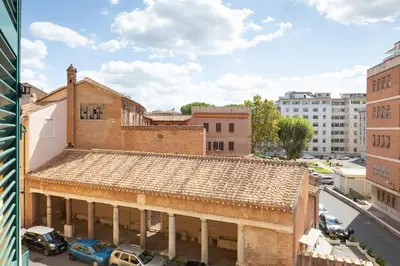 an old building with a tile roof in a city at Mini appartamento Colosseo in Rome