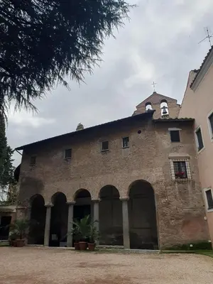 a large brick building with a cross on top at Mini appartamento Colosseo in Rome