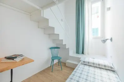 a room with a staircase and a chair and a desk at Mini appartamento Colosseo in Rome