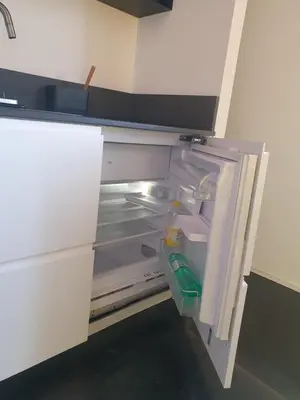 an empty refrigerator with its door open in a kitchen at Mini appartamento Colosseo in Rome