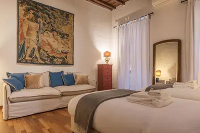 a bedroom with a large bed and a couch at Unique opportunity to live in a Renaissance palace - AC/WI-FI in Rome
