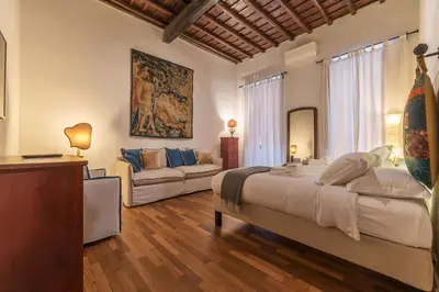 a bedroom with a large bed and a couch at Unique opportunity to live in a Renaissance palace - AC/WI-FI in Rome