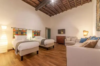 a large room with two beds and a couch at Unique opportunity to live in a Renaissance palace - AC/WI-FI in Rome