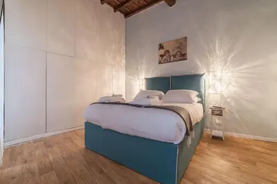 a bedroom with a blue bed in a room at Unique opportunity to live in a Renaissance palace - AC/WI-FI in Rome