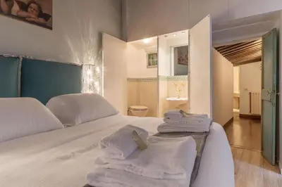 a bedroom with a bed with towels on it at Unique opportunity to live in a Renaissance palace - AC/WI-FI in Rome