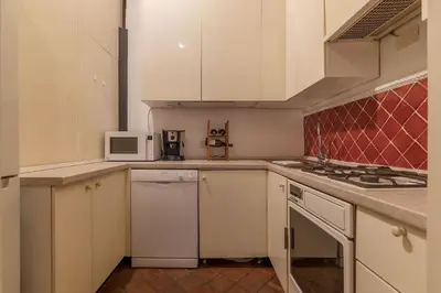 a kitchen with white cabinets and a stove top oven at Unique opportunity to live in a Renaissance palace - AC/WI-FI in Rome