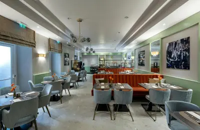 a restaurant with tables and chairs in a room at Leonardo Boutique Hotel Rome Monti in Rome