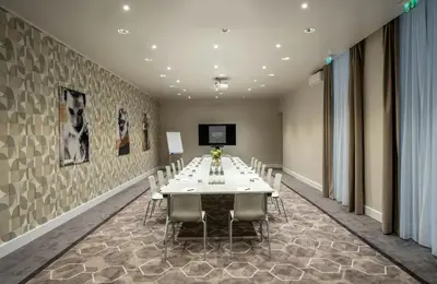 a conference room with a white table and chairs at Leonardo Boutique Hotel Rome Monti in Rome