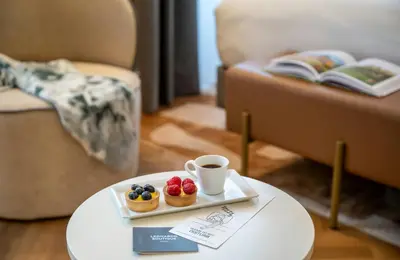 a tray of fruit and a cup of coffee on a table at Leonardo Boutique Hotel Rome Monti in Rome