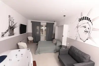 a living room with a bed and a bath tub at O.Effe. Suites / Vatican in Rome