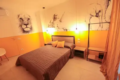 a bedroom with a bed and some drawings on the wall at O.Effe. Suites / Vatican in Rome