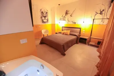 a bathroom with a bed and a bath tub at O.Effe. Suites / Vatican in Rome