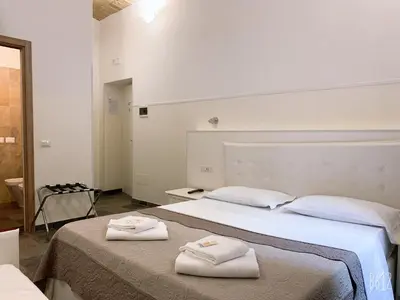 a hotel room with two beds with towels on them at Golden Nice in Rome