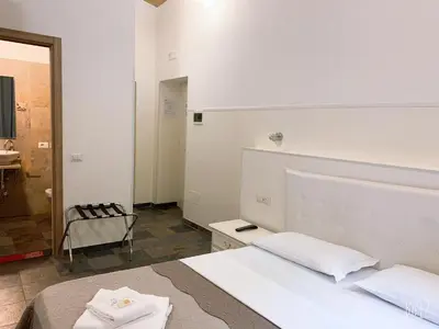 a white room with a bed and a bathroom at Golden Nice in Rome