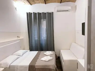 a small room with a bed and a window at Golden Nice in Rome