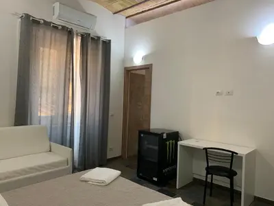 a room with a bed and a desk and a chair at Golden Nice in Rome