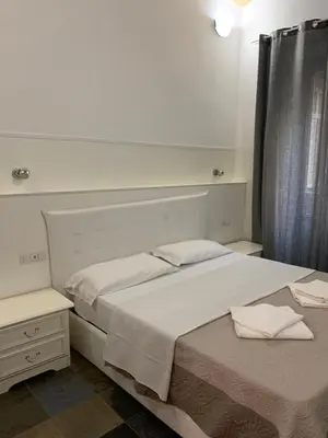 a bedroom with a large white bed and a window at Golden Nice in Rome