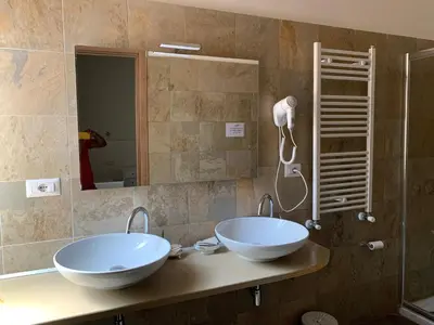 a bathroom with two sinks and a shower at Golden Nice in Rome