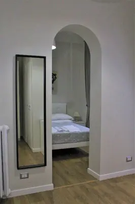 a bedroom with a mirror and a bed in it at The Castle Inside Rome in Rome