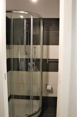 a shower in a bathroom with black and white stripes at The Castle Inside Rome in Rome