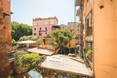 an overhead view of an alley with buildings and trees at Colosseum nest in Rome