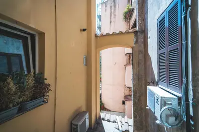 an alley in a building with an open window at Colosseum nest in Rome
