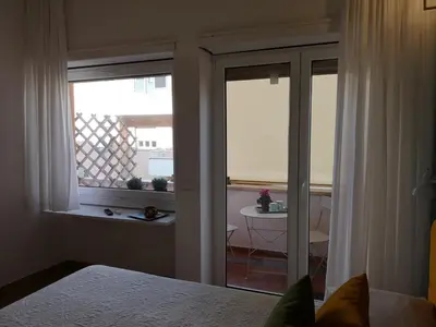 a bedroom with a bed and a window and a table at Affreschi al Vaticano in Rome