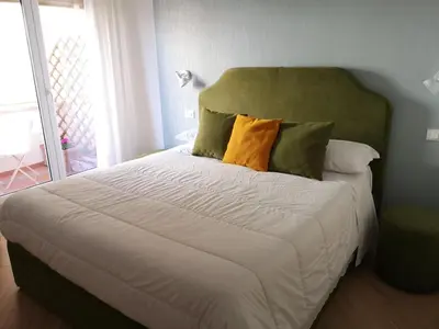 a bedroom with a large bed with two pillows at Affreschi al Vaticano in Rome