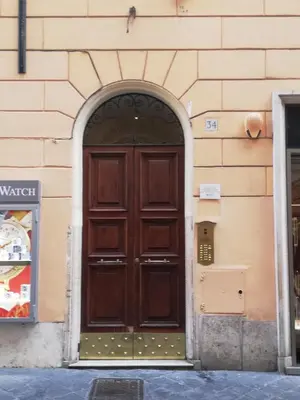 a large wooden door on the side of a building at Elegant Rooms Roma - Guest House in Rome
