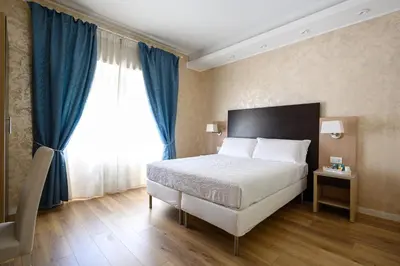 a bedroom with a bed and a large window at La Meraviglia- San Pietro - Vatican Area in Rome