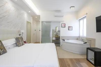 a bedroom with a large bed and a bath tub at La Meraviglia- San Pietro - Vatican Area in Rome