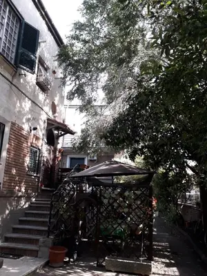 a table with an umbrella in front of a building at B&BGarbatella in Rome
