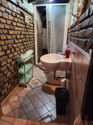 a bathroom with a sink and a brick wall at B&BGarbatella in Rome
