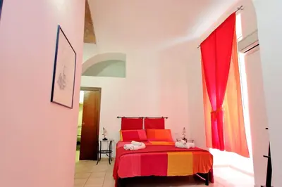 a bedroom with a red bed and a window at Lucky Holidays in Rome