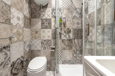 a bathroom with a toilet and a shower and a sink at Kyterion Apartment in Rome