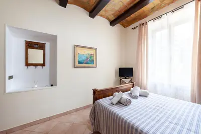 a bedroom with a bed and a large window at Kyterion Apartment in Rome