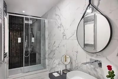 a bathroom with a sink and a mirror at Fellini Design Suites in Rome