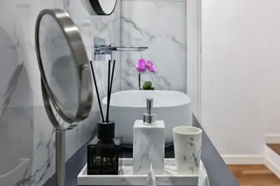 a bathroom with a sink and a mirror at Fellini Design Suites in Rome