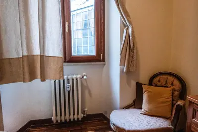 a room with a chair and a window and a radiator at La Vite 94 in Rome