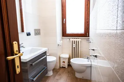 a bathroom with a sink and a toilet and a window at La Vite 94 in Rome